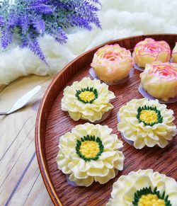High angle view of sweet food made in floral pattern served on table