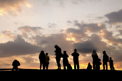 Silhouette people against sky during sunset