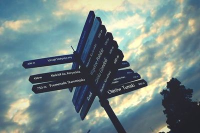 Low angle view of road sign against sky