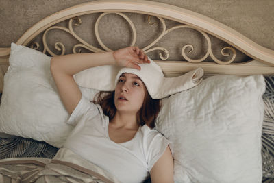 Portrait of young woman sitting on sofa at home