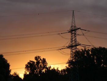 Low angle view of silhouette trees against sky during sunset