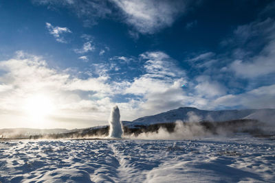 Scenic view of waterfall against sky