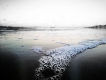 Close-up of frozen sea against sky