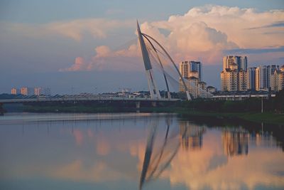 Reflection of buildings in city at sunset