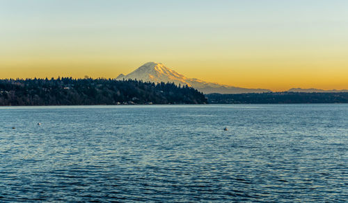 Mount rainier across the puget sound at twilight. photo taken from burien, washington.