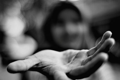 Defocused image of woman gesturing against blurred background