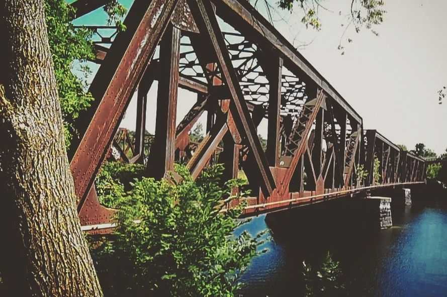 LOW ANGLE VIEW OF BRIDGE OVER RIVER AGAINST SKY