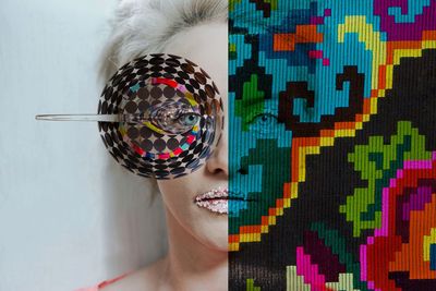 Close-up portrait of woman with multi colored face