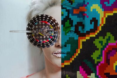 Digital composite image of woman with make-up and colorful pattern against wall