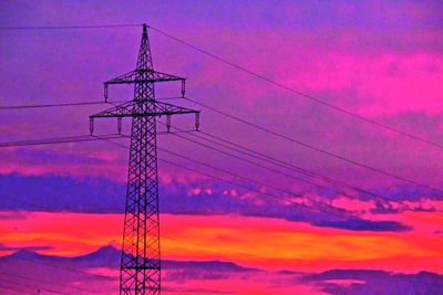 Low angle view of silhouette electricity pylon against romantic sky