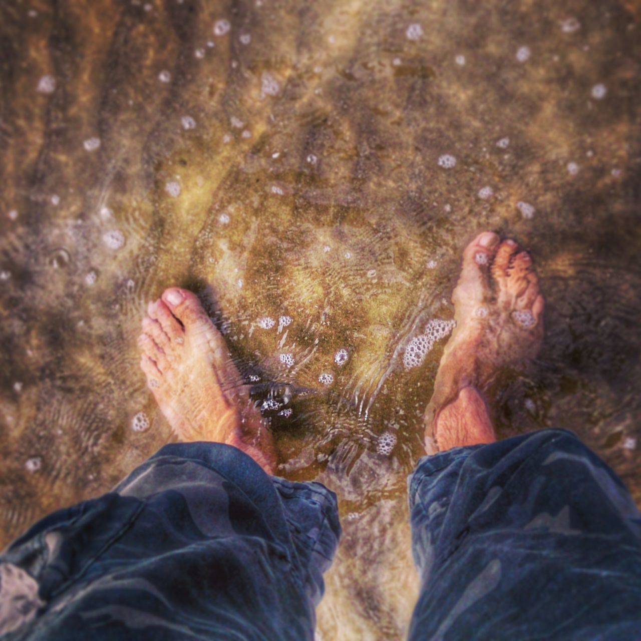 water, low section, person, lifestyles, leisure activity, personal perspective, men, high angle view, standing, human foot, lake, barefoot, relaxation, nature, shoe, wet, outdoors