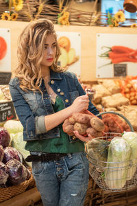 Portrait of young woman sitting at market