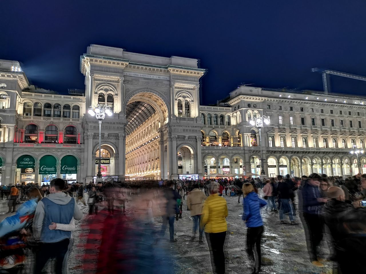 GROUP OF PEOPLE IN CITY AT NIGHT