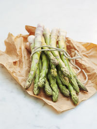 Green asparagus on wax paper