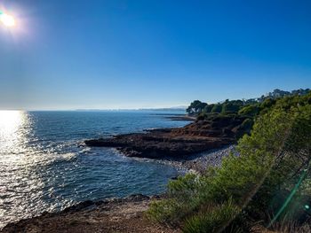 Scenic view of sea against clear blue sky