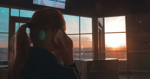Portrait of woman looking through window
