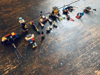 High angle view of group of toys on wood surface