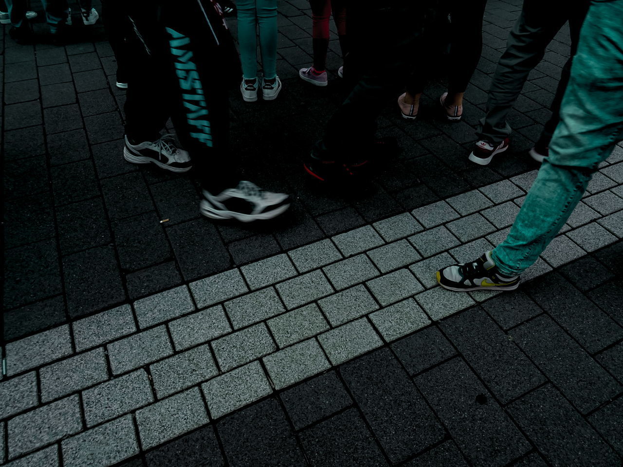 LOW SECTION OF PEOPLE STANDING ON STREET