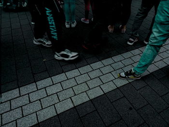 Low section of people walking on street