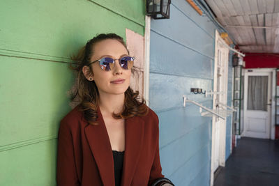 Portrait of woman in sunglasses standing outdoors