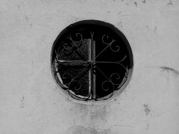 Low angle view of old window on wall