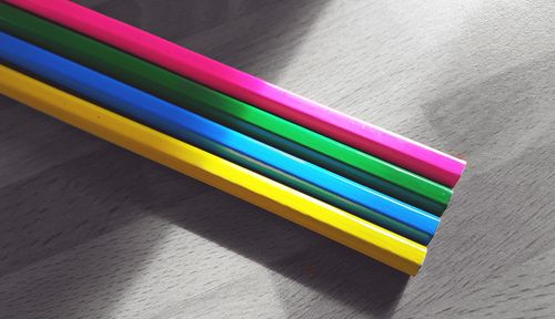 High angle view of colorful pencils on hardwood floor
