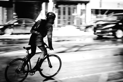 Man riding bicycle on city street