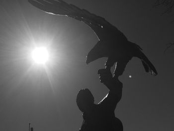 Low angle view of silhouette man against sky