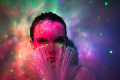 Portrait of woman with pink light painting at night