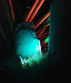 Low angle view of illuminated lighting equipment in dark