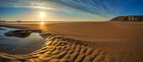 Scenic view of beach against sky during sunset