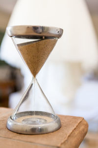 Close-up of hourglass on wooden table