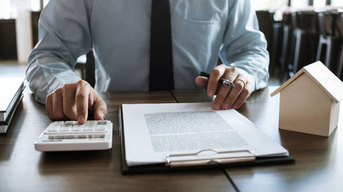 Midsection of business colleagues working on table