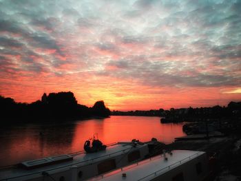 Scenic view of lake against orange sky