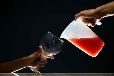 Guava juice being served in a glass goblet. isolated on dark background.