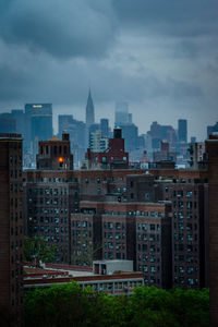 Cityscape against cloudy sky