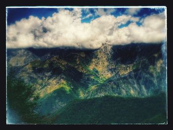 Scenic view of mountain against cloudy sky