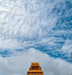 Low angle view of temple against cloudy sky