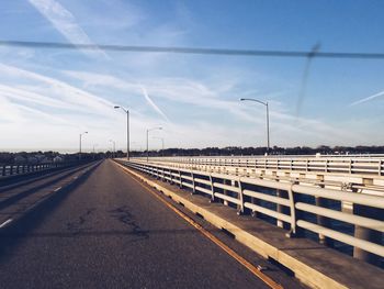 Railroad track against cloudy sky