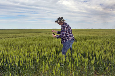 Man standing on field against sky