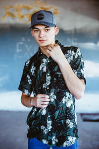 Portrait of young man wearing hat standing outdoors