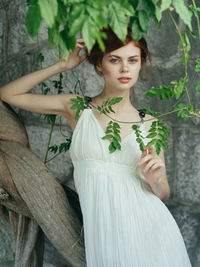 Portrait of woman against plants