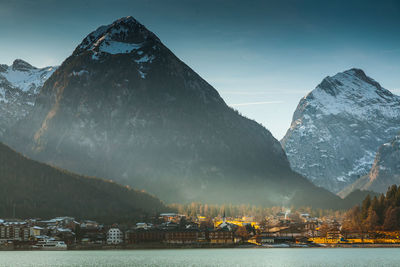 Scenic view of sea and mountains against sky