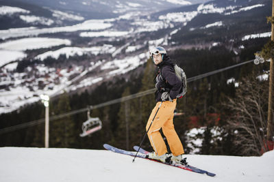 Man skiing on snowy mountain