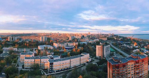 High angle view of cityscape against cloudy sky