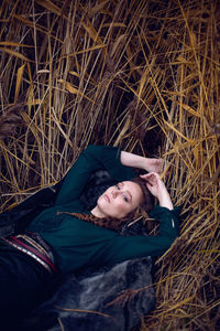 Fashionable woman in a green sweater and a long skirt keeps the fur