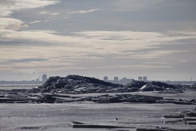 Ice floating on baltic sea against cloudy sky