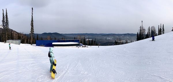 Person skiing on snow against sky