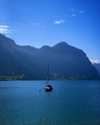 Sailboat sailing on sea against sky