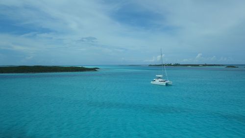Sailboats sailing in sea against sky